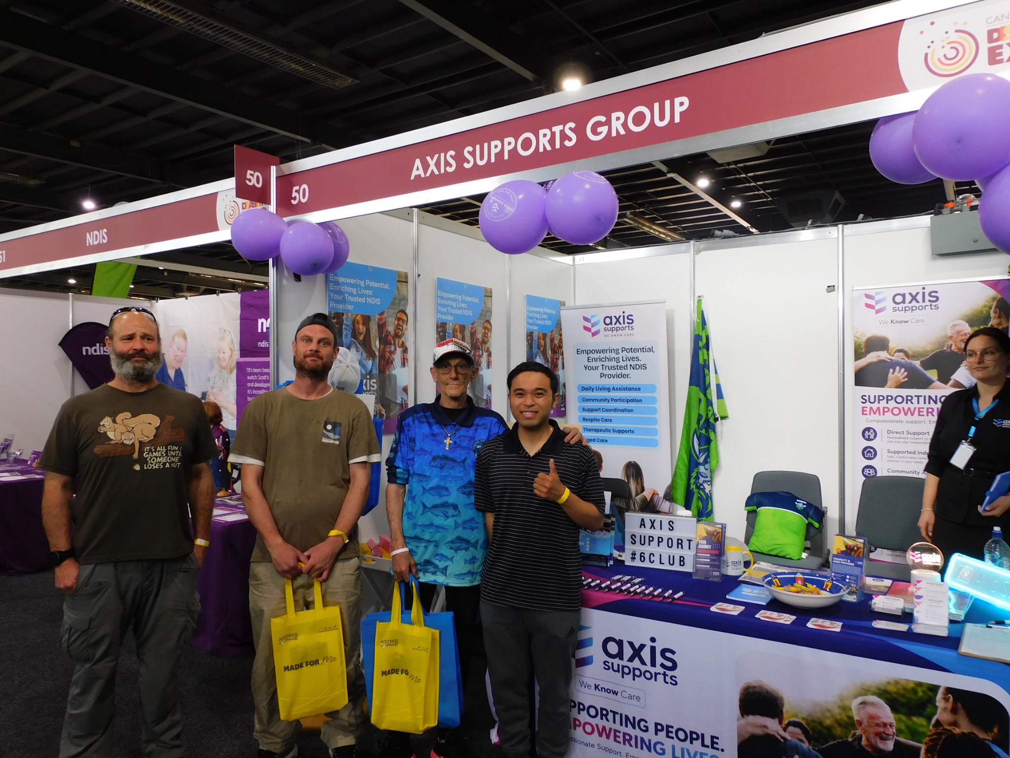A group together at the AXIS Supports expo stand