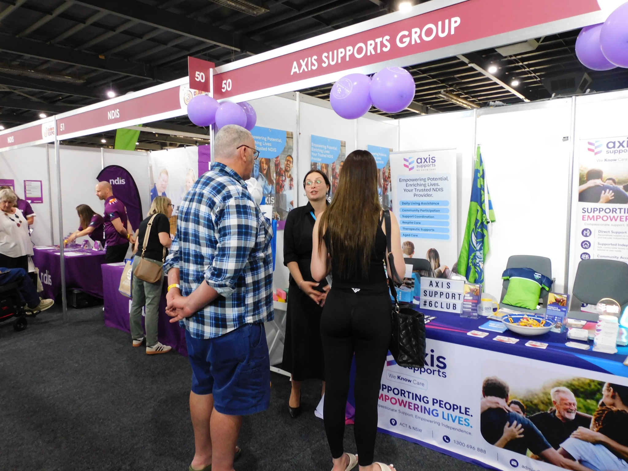 A conversation at the AXIS Supports exhibition stand