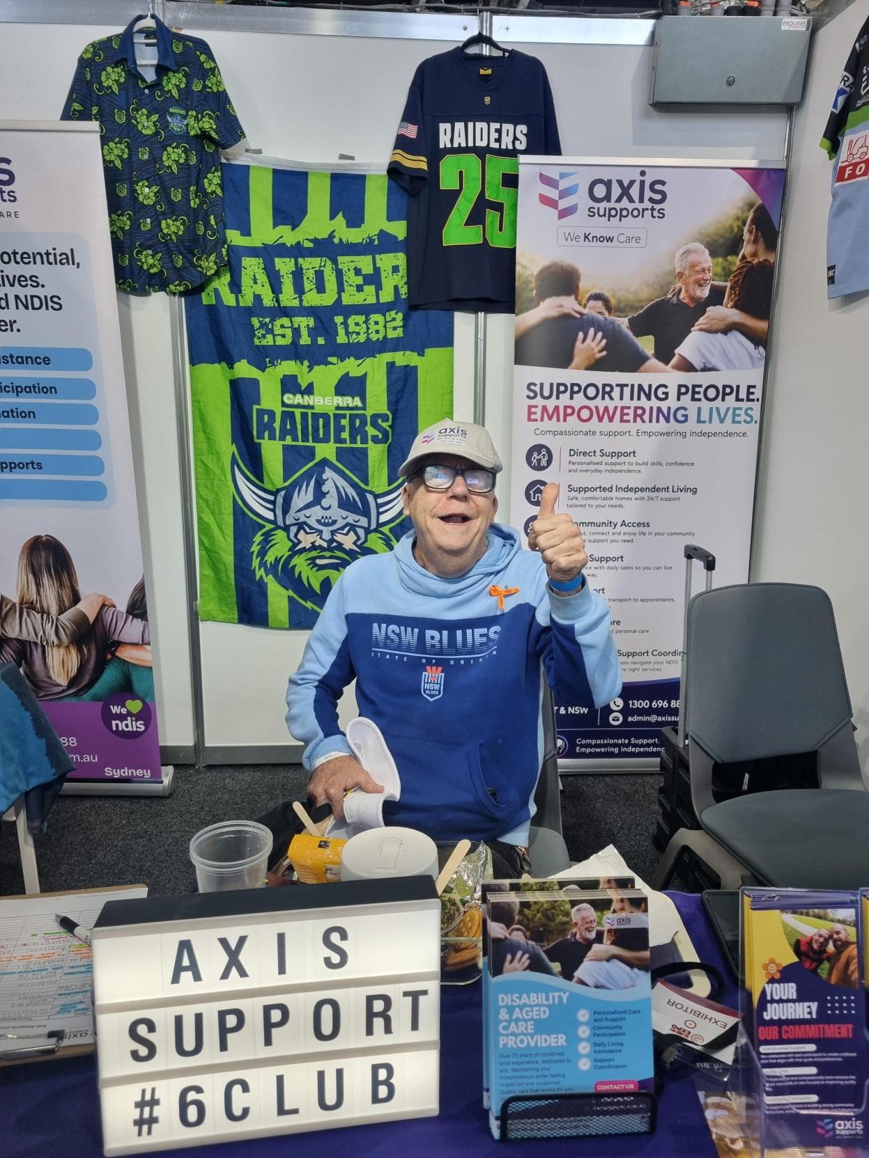 A visitor giving a thumbs-up at the AXIS exhibition stand